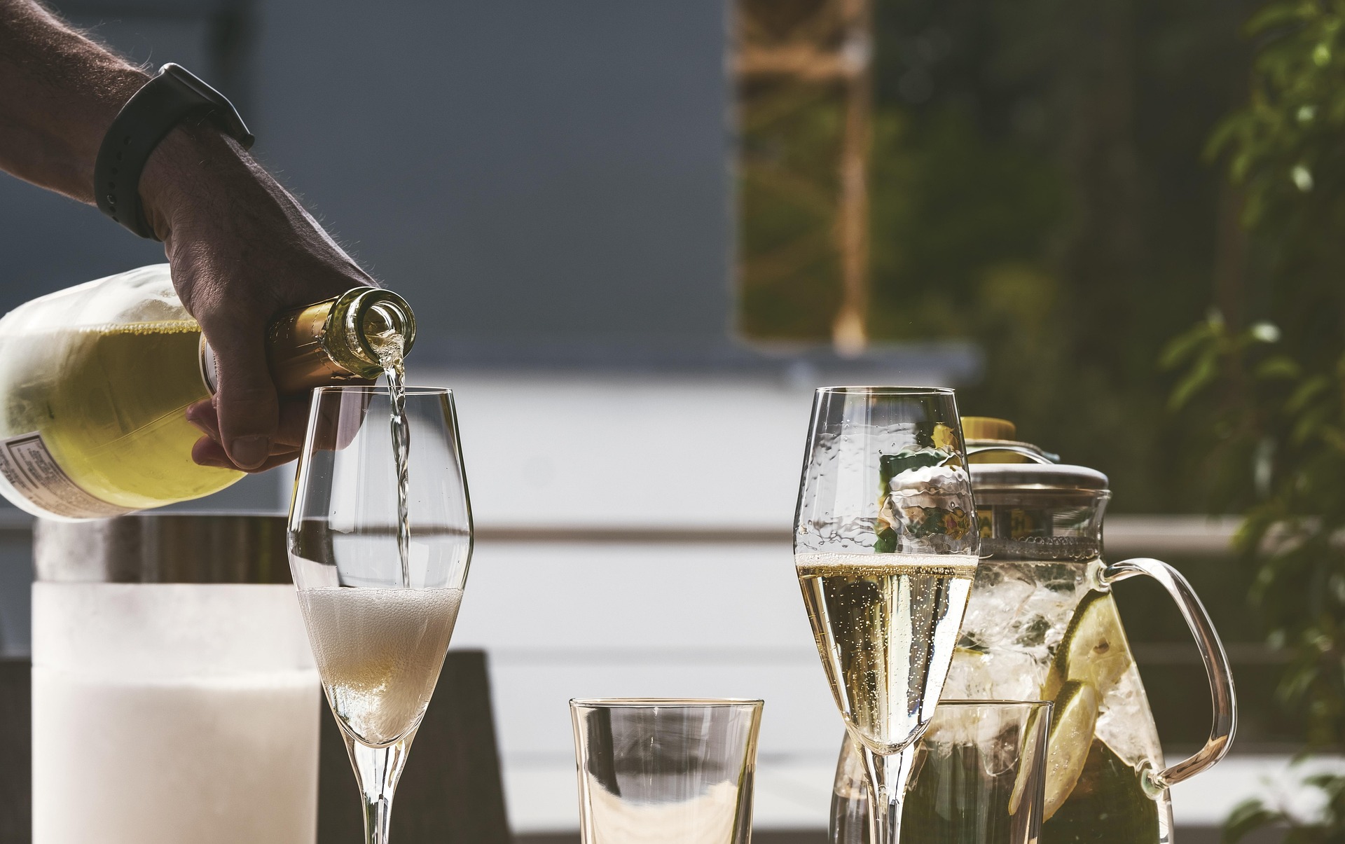 Pouring sparkling cava wine into flute glasses during a private tasting experience in Penedès